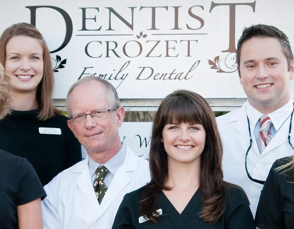 Dr. Willis and Dr. Taylor with early team members at the practice sign